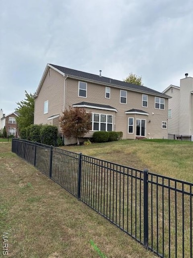 Back of property featuring a fenced backyard