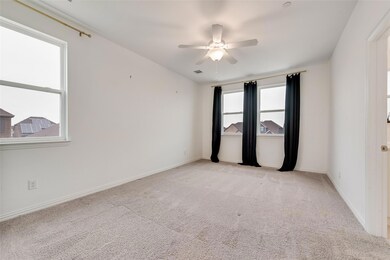 Spare room featuring light colored carpet and ceiling fan