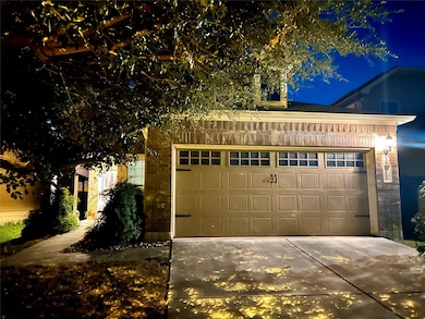 Garage at twilight featuring concrete driveway