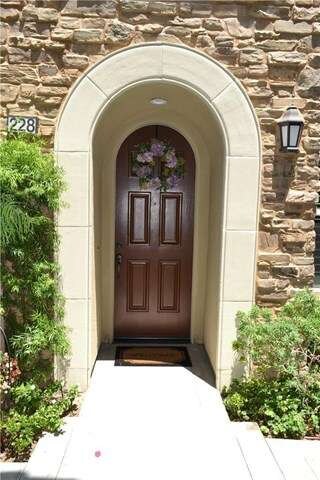 This lovely arched door and entry adds class and c