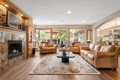 A warm and welcoming space, the living room showcases custom built-ins, gleaming maple finishes, and a gas fireplace—all within an open layout ideal for entertaining.