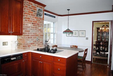 Updated Eat-In Kitchen Features Exposed Brick Wall