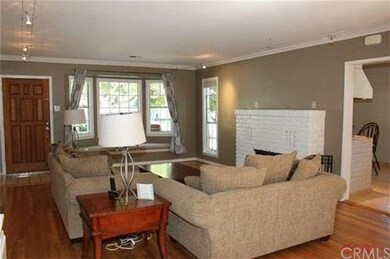 Living room with wood burning fireplace.  Doorway 