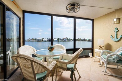Sunroom with a textured wall, a water view, tile patterned floors, floor to ceiling windows, and a textured ceiling