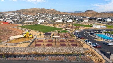 Aerial view of residential area featuring a mountainous background and a pool area