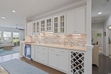 Kitchen with dark wood-type flooring, white cabine