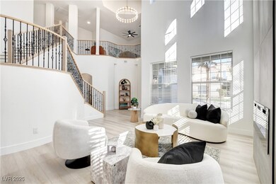 Living area featuring a high ceiling, stairway, he