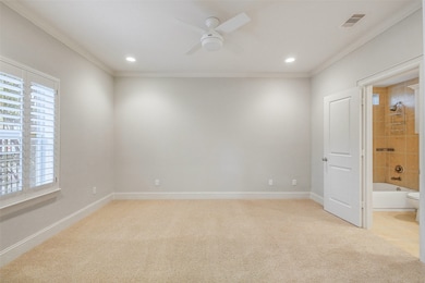Spacious main-level bedroom with abundant natural light, neutral finishes and versatile layout