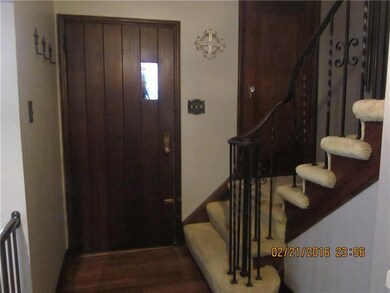 Center hallway with original woodwork, wrought iro