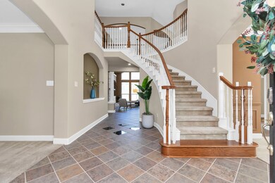Step into elegance as a grand two-story foyer welc