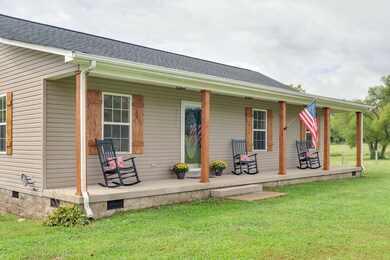 Front porch extends length of home while cedar posts & matching shutters complement the home!