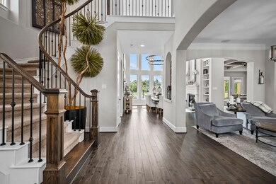 Once inside this impressive two story entrance you are met by a sweeping staircase and views of the lake through the dining room.
