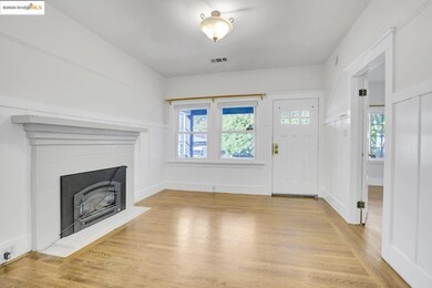 Entryway with light wood finished floors and a brick fireplace