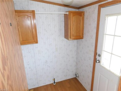 Laundry room with exterior door.