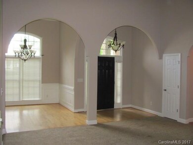 Front foyer and Dining Room with matching chandeli