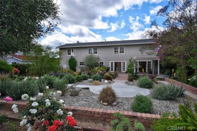 Roses, walking paths, brick planters and flat yard on over 11,000 s.f. lot