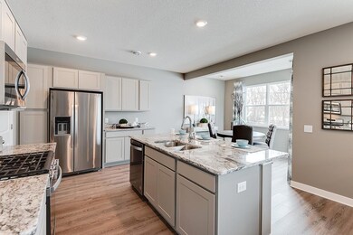 Large kitchen island, stainless appliances, ample cabinet space all compliment this chef's dream. *Staged Model photo, actual selections and options may vary.