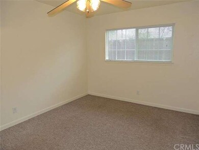 Spacious carpeted bedroom.