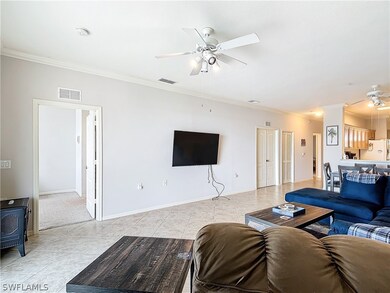 Tiled living room featuring ceiling fan and orname