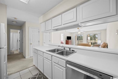 Kitchen featuring dishwasher, sink, white fridge, 