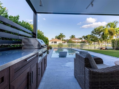 State of the art summer kitchen , overlooking the pool and lake..