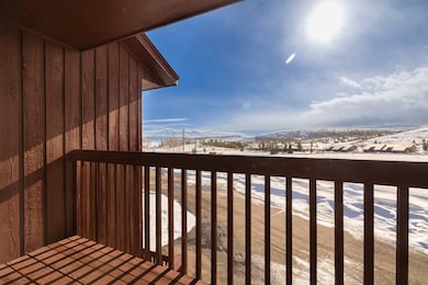 Snow covered back of property featuring a mountain