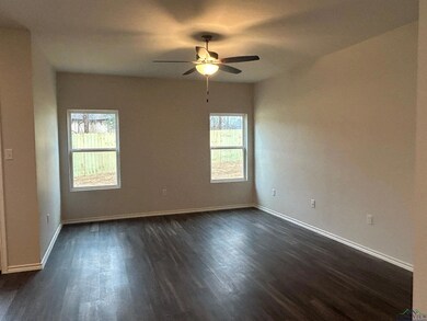 Spare room with dark wood-type flooring and ceilin