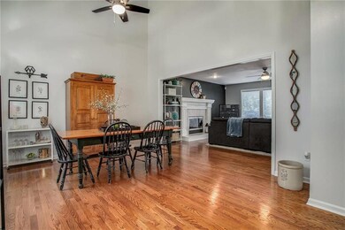Hardwood floors and a vaulted ceiling with lighted