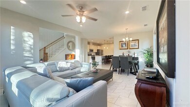 Living room featuring recessed lighting, ceiling fan, a chandelier, stairway, and light tile patterned floors