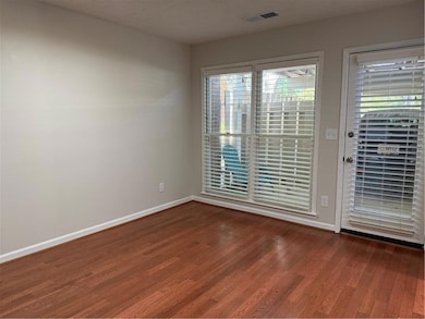 Empty room with dark wood finished floors and baseboards