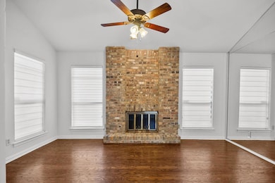 Unfurnished living room with ceiling fan, dark har