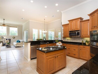 Kitchen is complete with Granite Countertops, Island with veggie sink, closet pantry, Breakfast Bar, recessed lighting, built in desk and crown molding!