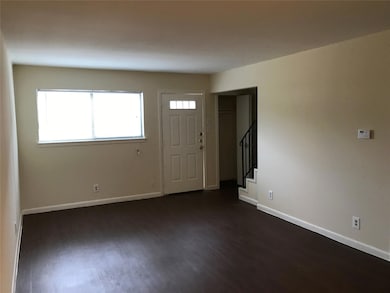 Entryway featuring dark wood-style floors, basebo
