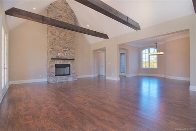 Custom beams and a stacked stone fireplace make th