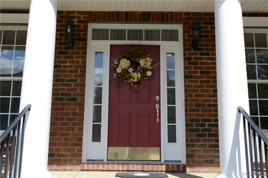 Welcoming  aggregate & brick front porch with a fr
