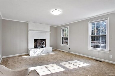 Family room view to the brick wood burning firepla