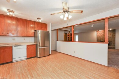 Kitchen featuring a textured ceiling, brown cabine