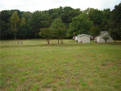 VIEW FROM JUST BEHIND THE HOUSE. NOTICE A LARGE GA