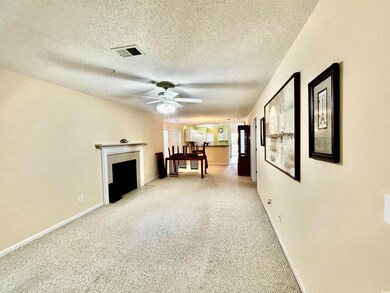 Unfurnished living room with light carpet, a textu