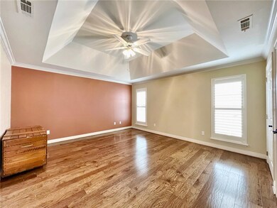 Master Bedroom with tray ceiling and plantation sh