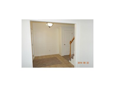 Tiled entryway, with updated light fixture