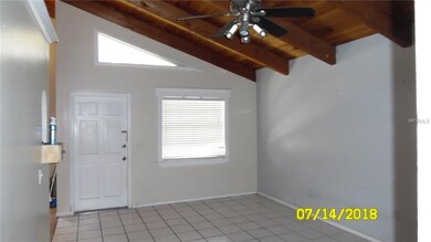 Living room with vaulted natural wood beam ceiling