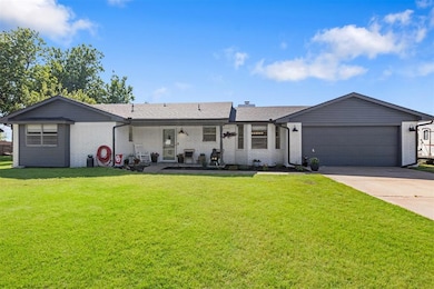 Back of house featuring brick siding, concrete driveway, and a garage