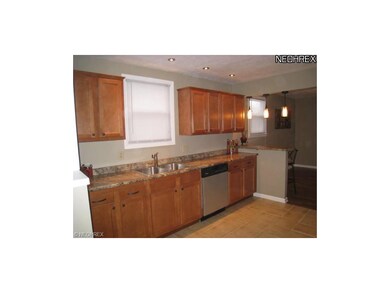 Remodeled kitchen with ceramic tile floor.