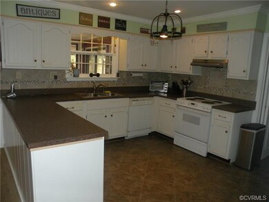 Kitchen with ceramic backsplash, window is into Fl