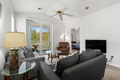 Living room with lofted ceiling, ceiling fan, and 