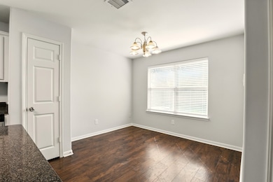 The photo shows a bright dining area with dark woo