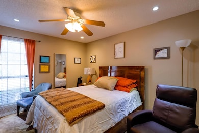 Bedroom with lots of natural light, ceiling fan, a