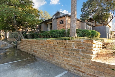 View of side of property with brick siding and fen