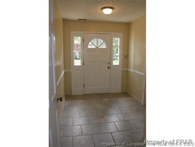 Tiled foyer w/ coat closet